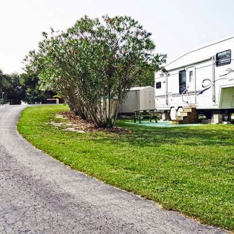 A beautiful, well-maintained home in Lake Letta RV Park, surrounded by lush greenery in the serene 55+ community of Avon Park, FL.