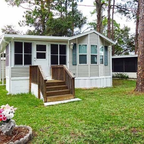 A beautiful, well-maintained home in Lake Letta RV Park, surrounded by lush greenery in the serene 55+ community of Avon Park, FL.