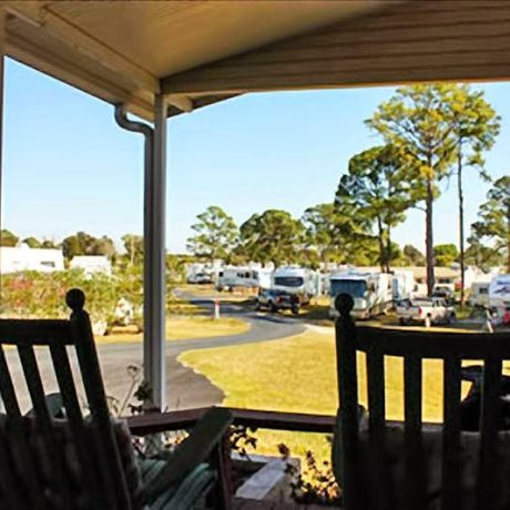 A covered patio outside one of the available homes at Lake Letta RV Park, offering a peaceful place to relax and enjoy the Florida scenery in Avon Park, FL.