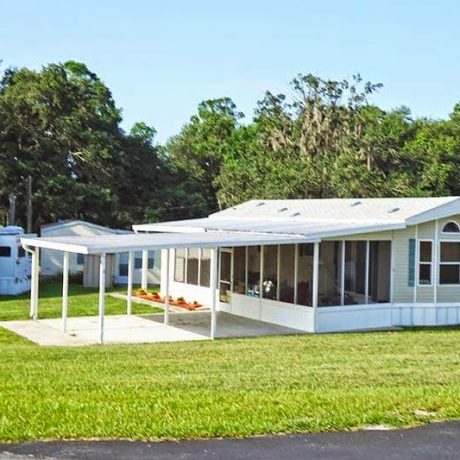 A covered patio outside one of the available homes at Lake Letta RV Park, offering a peaceful place to relax and enjoy the Florida scenery in Avon Park, FL.