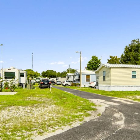 The exterior of a tropical-style clubhouse where seniors can enjoy activities and events at Lake Letta RV Park in Avon Park, FL.