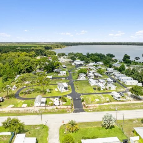 A wide-angle view of Lake Letta RV Park, showcasing the homes and beautifully landscaped surroundings in the 55+ community of Avon Park, FL.